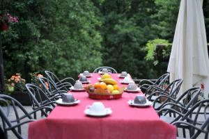 a table with a red table cloth and a bowl of fruit at Eremo Montemezzano in Pratovecchio