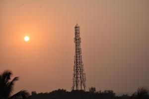 a cell phone tower with the sun in the sky at Hotel GANANJAYA in Gokarna