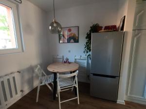 a small kitchen with a table and a refrigerator at M37 Apartment Limanowa Beskid Base in Limanowa
