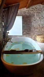 a bath tub in a room with a window at Town House Rosario in Stari Grad