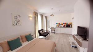 a living room with a couch and a television at MIKA Studios in Eforie Nord +104 photos