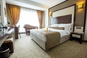 a hotel room with a large bed and a desk at Lavin Hotel & Spa in Denizli