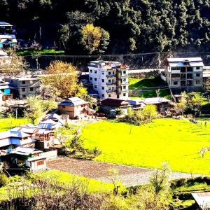 an aerial view of a city with buildings and a field at Midway Lodges Neelum Valley in Nīlam