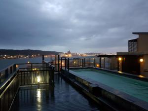 a swimming pool on top of a building next to the water at 307 Point Bay in Durban