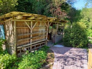 uma pérgola de madeira no meio de um jardim em Alte Mühle em Holzminden