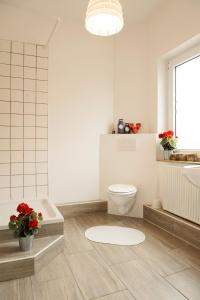 W łazience znajduje się toaleta, wanna i umywalka. w obiekcie Alpen Stub'l w Bremie