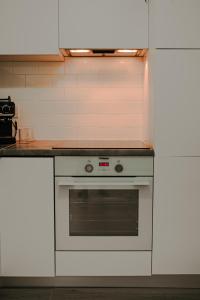 a kitchen with a white oven and a counter at SunsetView Apartment in Oradea