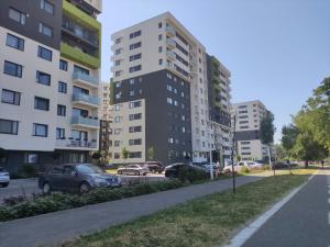 a street in a city with tall buildings at SunsetView Apartment in Oradea