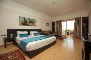 a bedroom with a large bed and a living room at Ocean Atlantic View (Ex Bo Hotel) in Agadir