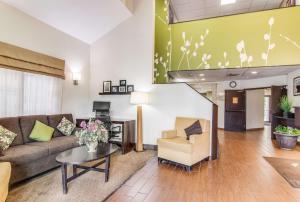 a living room with a couch and a table at Sleep Inn in Austintown