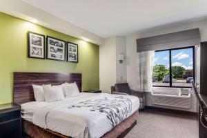 a hotel room with a large bed and a window at Sleep Inn Austintown - Youngstown, West in Austintown +29 photos