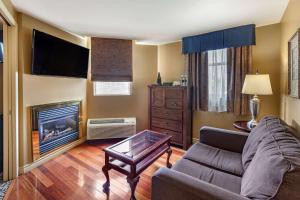 a living room with a couch and a fireplace at The Parlour Inn Ascend Hotel Collection in Stratford
