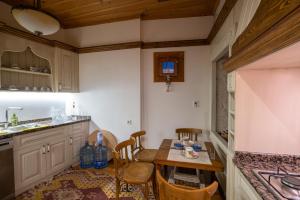 a kitchen with a table and chairs and a sink at Cedrus Hotel in Antalya