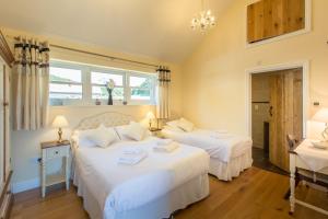 a bedroom with two beds and a sink at Ty Llo in Kidwelly