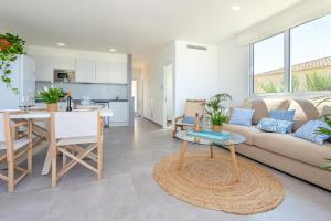 a living room with a couch and a table at Apartment Jedy Balear By homevillas360 in Son Serra de Marina