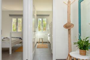 a hallway with a door leading to a bedroom at Apartment Jedy Balear By homevillas360 in Son Serra de Marina