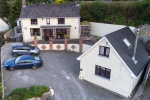 an aerial view of a house with a car parked in a driveway at The Lodge in Newcastle Emlyn