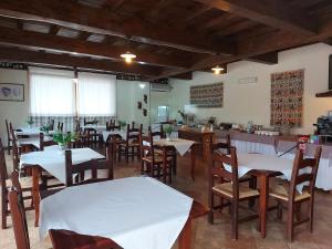 a restaurant with tables and chairs and a bar at Hotel Plammas in Santa Maria Navarrese