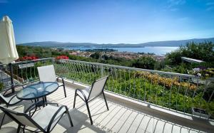 a balcony with chairs and a table and a view of the water at Apartment Lana in Tivat
