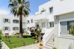 an image of a villa with a palm tree at Angela Studios Apartments in Sisi