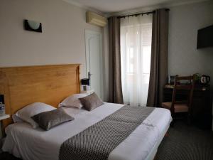 Postelja oz. postelje v sobi nastanitve Hostellerie du Val d'Or