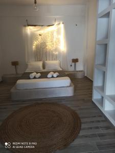a bedroom with a large bed with lights on it at Cactus Home in Kalamaki Heraklion