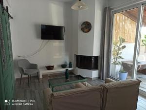 a living room with a couch and a fireplace at Cactus Home in Kalamaki Heraklion