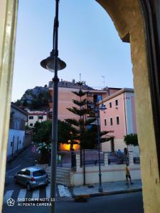 una vista desde una ventana de una calle con un árbol en Room Rome, en Roccella Ionica