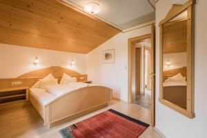a bedroom with a large white bed in a room at Landhaus Kristall in Leutasch