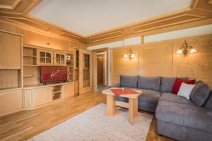 a living room with a couch and a table at Landhaus Kristall in Leutasch