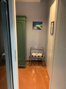 a hallway with a green cabinet and a bed at Hotel Elu Iris in Split