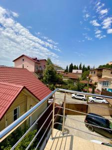 a balcony of a house with a car on it at Апартаменты люкс in Adler