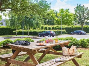 a wooden picnic table with food and drinks on it at hotelF1 Roissy CDG Pn2 in Roissy-en-France