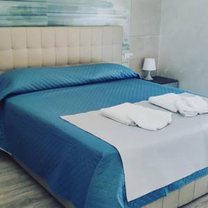 - un lit bleu et blanc avec 2 oreillers dans l'établissement B & B LE GEMELLINE, à Salerne