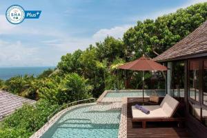 a resort with a swimming pool and an umbrella at Silavadee Pool Spa Resort - SHA Extra Plus in Lamai