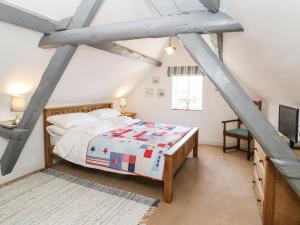 a attic bedroom with a bed and a tv at Regent House in Scarborough