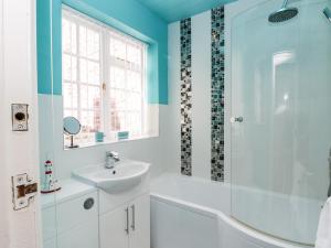 a bathroom with a white sink and a shower at Regent House in Scarborough +27 photos