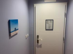 a door in a room with a picture on the wall at Hotel Elu Iris in Split