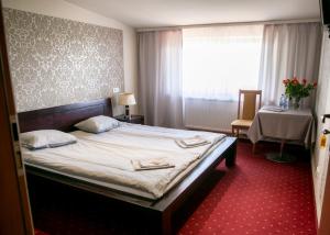a bedroom with a bed with two towels on it at Kamionki in Sosnowiec