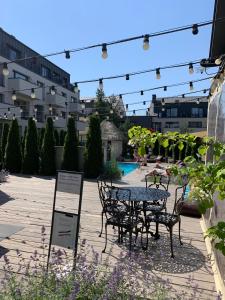a patio with a table and chairs in a courtyard at Old Mill Apartamentai - Palanga in Palanga