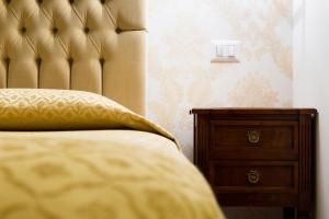 un letto con cuscino e cassettiera in una camera da letto di Hotel Bramante a Todi
