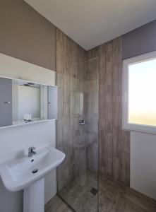 a bathroom with a sink and a shower at Imperial Hotel in Shënkoll