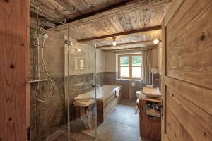 a bathroom with a shower and a sink and a tub at Lass Zeit am Lech in Bach