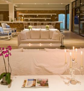 a room with two couches and a table with candles at Sandy Beach Hotel & Spa - ex Sentido in Larnaca