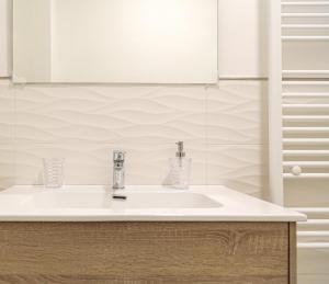 a bathroom with a white sink and a mirror at Casa Clementina Rooms vista mare in Porto Cesareo +101 photos