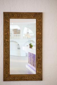 a picture of a mirror on a wall at Sandy Beach Hotel & Spa - ex Sentido in Larnaca