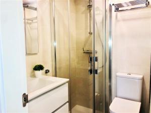 a bathroom with a shower and a toilet and a sink at Rentcostadelsol Fuengirola Doña Sofia 3D in Fuengirola +18 photos