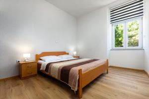 Säng eller sängar i ett rum på Apartments Smaila 1729