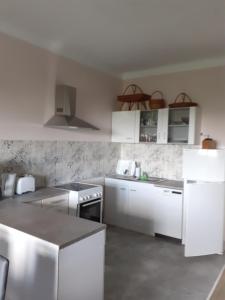 a kitchen with white appliances and white cabinets at Rosentraum in Hain
