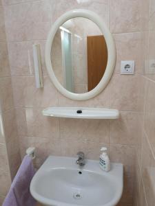 a bathroom with a sink and a mirror at Marija in Šibenik